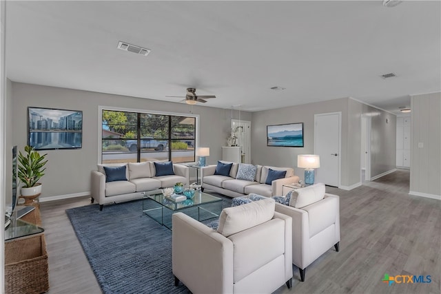 living room featuring hardwood / wood-style floors and ceiling fan