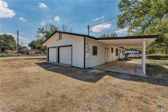 view of property exterior with a garage and a carport