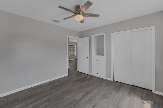 unfurnished bedroom featuring ceiling fan, a closet, and wood-type flooring