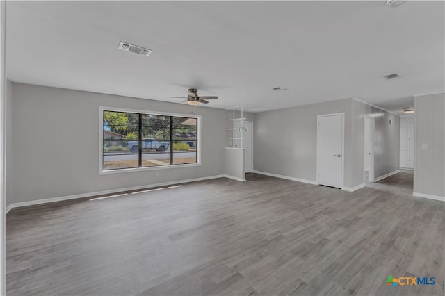 unfurnished living room with hardwood / wood-style flooring and ceiling fan