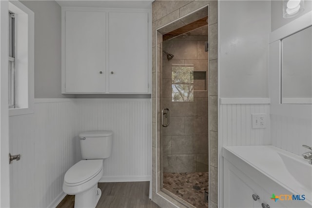 bathroom featuring hardwood / wood-style floors, vanity, toilet, and an enclosed shower