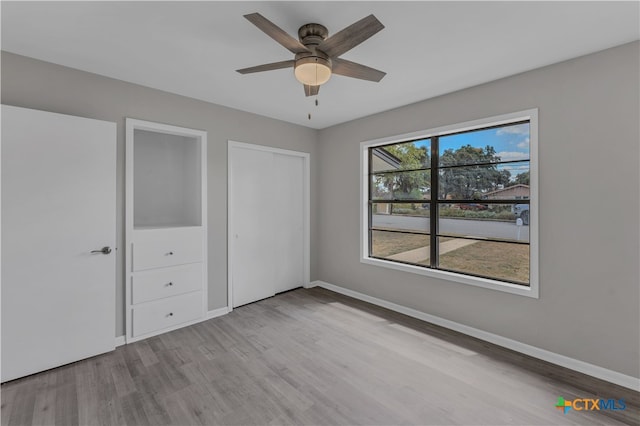 unfurnished bedroom featuring a closet, light hardwood / wood-style floors, and ceiling fan