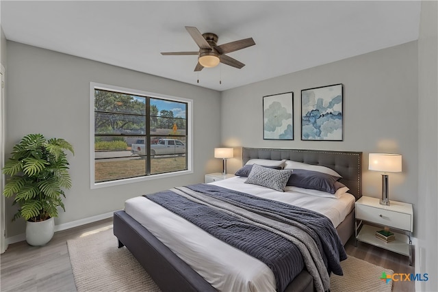 bedroom featuring ceiling fan and light hardwood / wood-style flooring