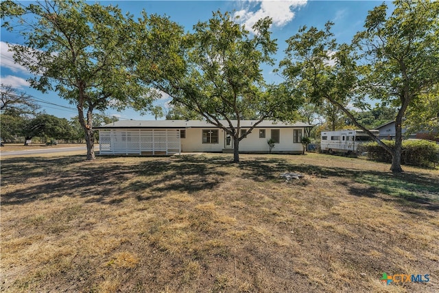 back of property featuring a yard