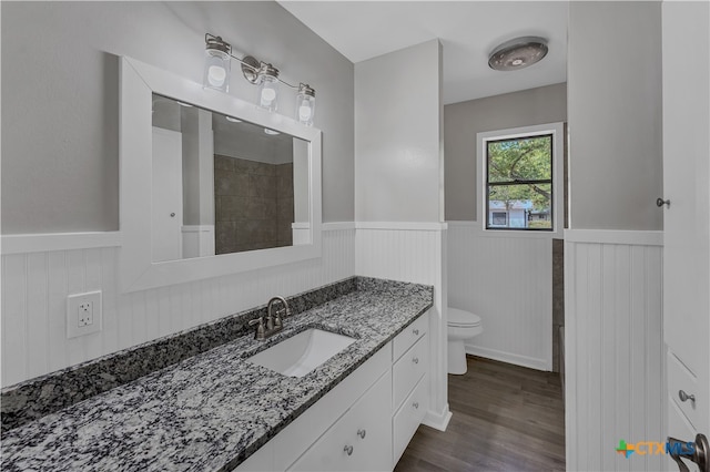 bathroom featuring hardwood / wood-style flooring, vanity, and toilet