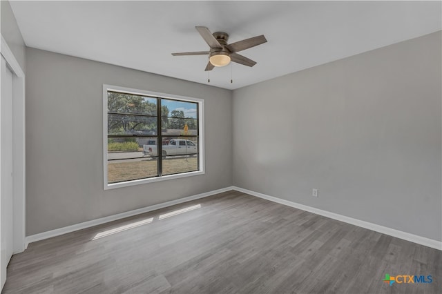 unfurnished bedroom with light hardwood / wood-style floors, ceiling fan, and a closet