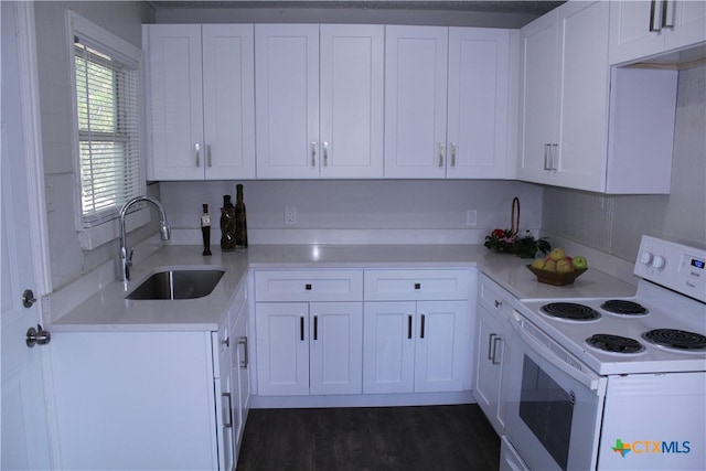 kitchen featuring sink, dark hardwood / wood-style floors, white range with electric cooktop, a textured ceiling, and white cabinets