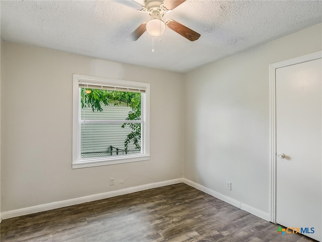 spare room featuring a textured ceiling, dark hardwood / wood-style flooring, and ceiling fan