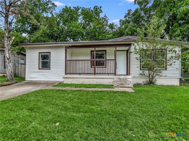 single story home with covered porch and a front lawn