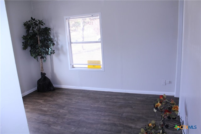 unfurnished room featuring dark hardwood / wood-style floors