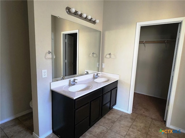 bathroom featuring tile patterned flooring, vanity, and toilet