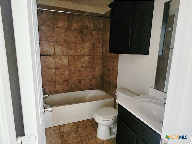 full bathroom with tiled shower / bath, tile patterned flooring, vanity, and toilet