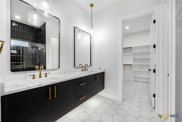 303 W Lane Ave, Manor, TX 78653 - full bathroom with double vanity, tiled shower, tile patterned floors, and a spacious closet