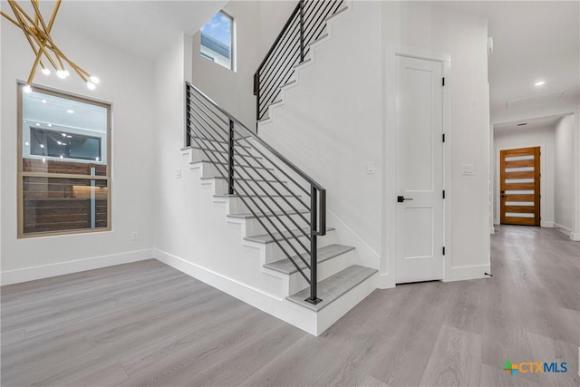 303 W Lane Ave, Manor, TX 78653 - staircase featuring wood finished floors and baseboards