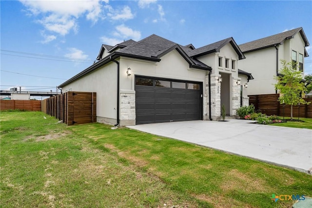 303 W Lane Ave, Manor, TX 78653 - view of front of home with stucco siding, stone siding, concrete driveway, and roof with shingles