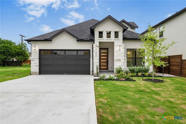 303 W Lane Ave, Manor, TX 78653 - modern home featuring stucco siding, an attached garage, concrete driveway, stone siding, and roof with shingles