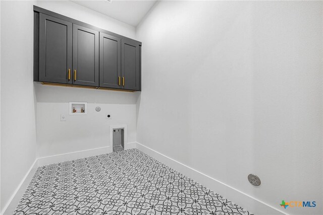 303 W Lane Ave, Manor, TX 78653 - washroom featuring washer hookup, hookup for a gas dryer, hookup for an electric dryer, and cabinet space
