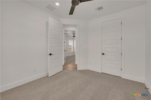 unfurnished bedroom with light carpet, baseboards, and visible vents