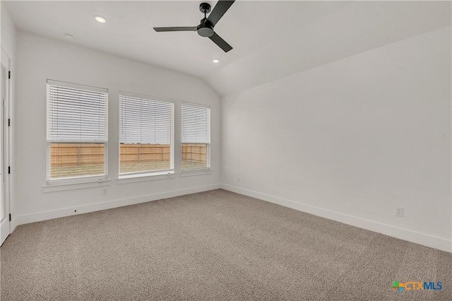 carpeted spare room with plenty of natural light, baseboards, vaulted ceiling, and recessed lighting