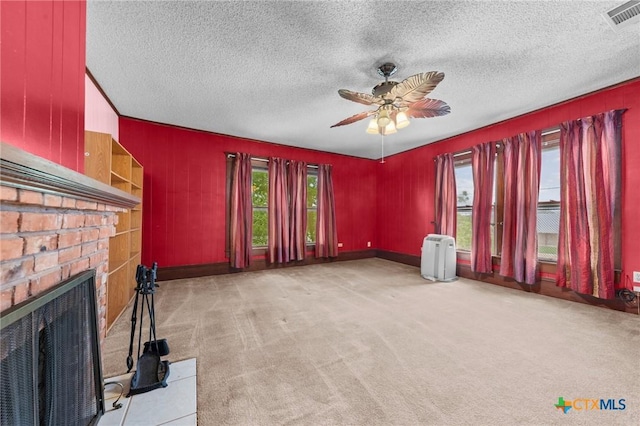 9 S Milam St, Rogers, TX 76569 - unfurnished living room with carpet flooring, a textured ceiling, visible vents, and a ceiling fan