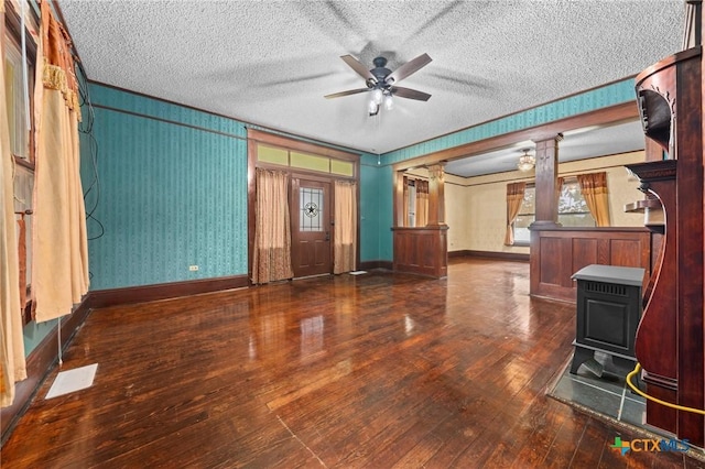 9 S Milam St, Rogers, TX 76569 - unfurnished living room with a ceiling fan, a textured ceiling, hardwood / wood-style floors, and ornate columns