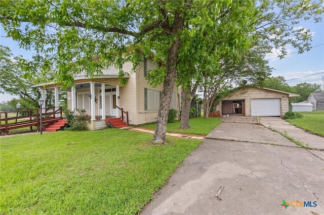 9 S Milam St, Rogers, TX 76569 - view of front of property with a front yard, an outdoor structure, covered porch, and a detached garage
