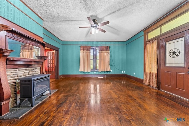 9 S Milam St, Rogers, TX 76569 - unfurnished living room featuring a textured ceiling, hardwood / wood-style floors, a ceiling fan, and plenty of natural light