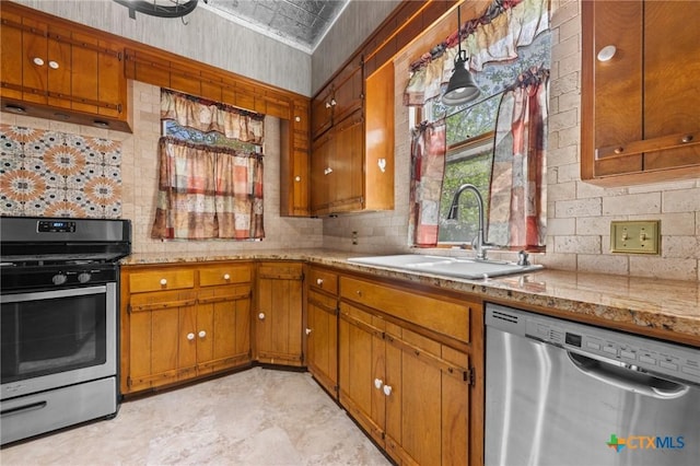 9 S Milam St, Rogers, TX 76569 - kitchen featuring a sink, brown cabinetry, backsplash, and appliances with stainless steel finishes