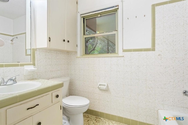 4412 Briar Cliff Rd, Temple, TX 76502 - bathroom with a shower, toilet, vanity, and tile walls