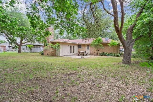 4412 Briar Cliff Rd, Temple, TX 76502 - back of property with a chimney, a patio area, and french doors