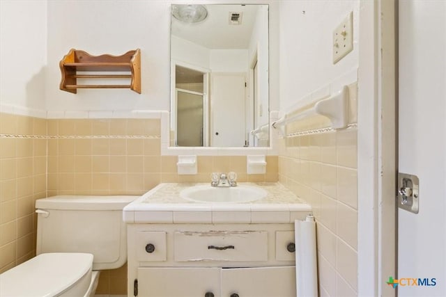 4412 Briar Cliff Rd, Temple, TX 76502 - full bathroom featuring a shower stall, tile walls, toilet, and vanity