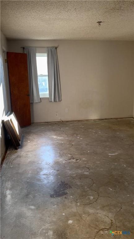 empty room featuring a textured ceiling