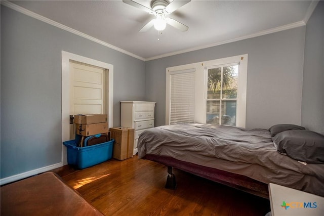 bedroom featuring wood finished floors, a ceiling fan, baseboards, and ornamental molding