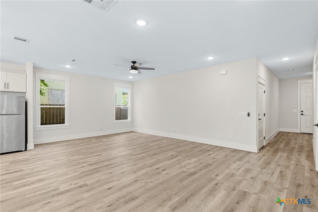 unfurnished living room featuring light hardwood / wood-style flooring and ceiling fan