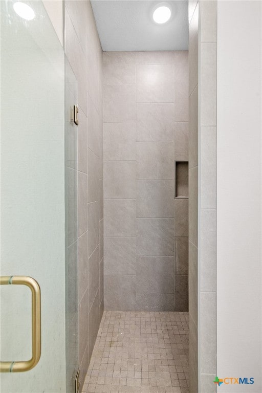 bathroom with a shower with shower door