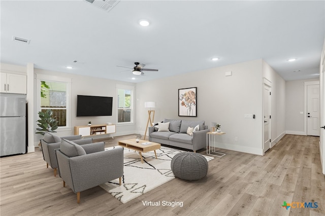 living room with light hardwood / wood-style floors and ceiling fan