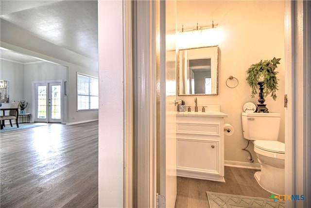 2605 Canyon Creek Dr, Temple, TX 76502 - bathroom with wood finished floors, toilet, baseboards, french doors, and vanity