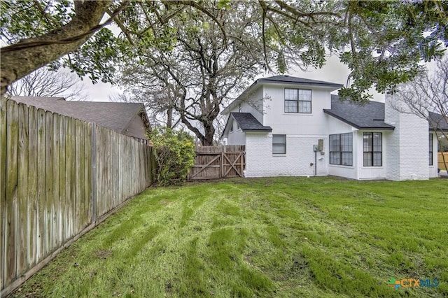 2605 Canyon Creek Dr, Temple, TX 76502 - back of house featuring brick siding and roof with shingles