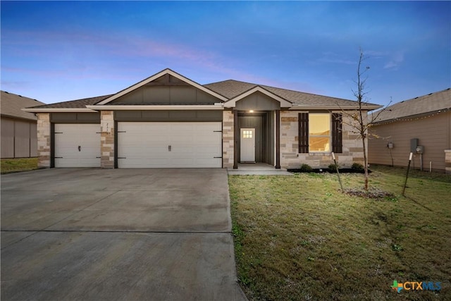 ranch-style home featuring a front lawn, concrete driveway, roof with shingles, a garage, and stone siding