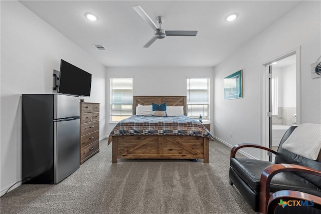 bedroom with multiple windows, carpet flooring, visible vents, and freestanding refrigerator