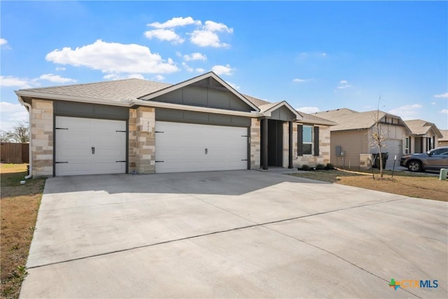 ranch-style home featuring an attached garage, stone siding, driveway, and roof with shingles