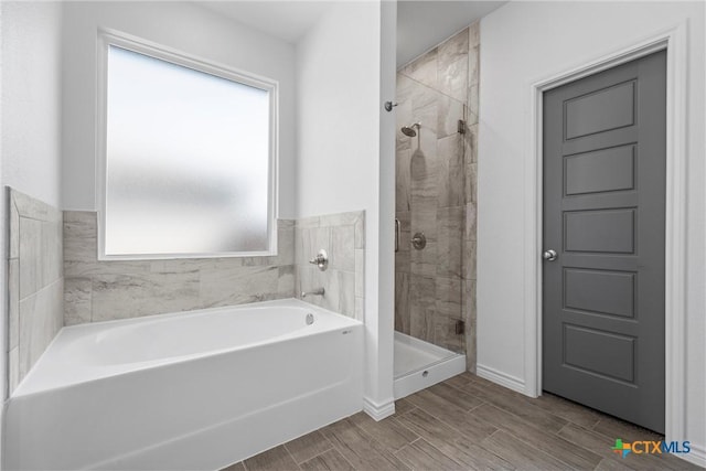 full bath with a garden tub, a stall shower, and wood finish floors