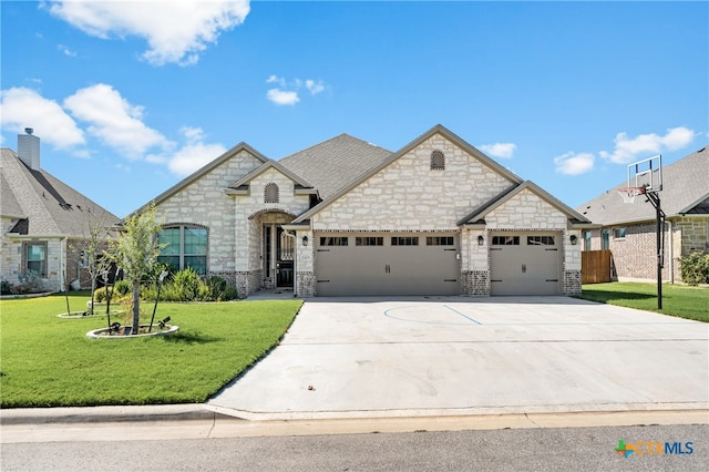 view of front of house with a garage and a front lawn