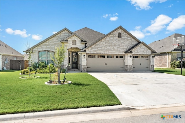 view of front of property with a front lawn and a garage