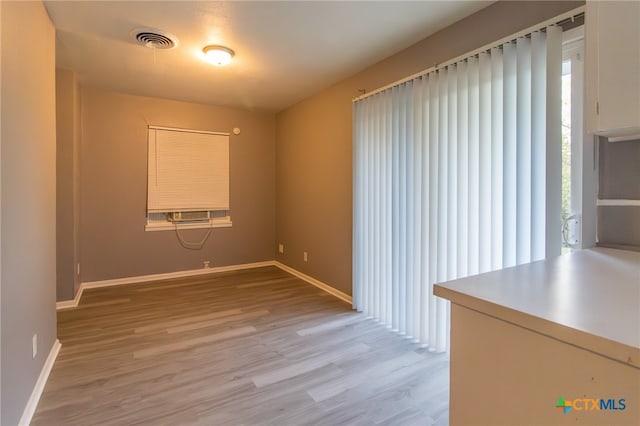 spare room with hardwood / wood-style flooring and cooling unit