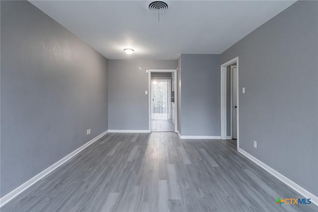 empty room with hardwood / wood-style flooring