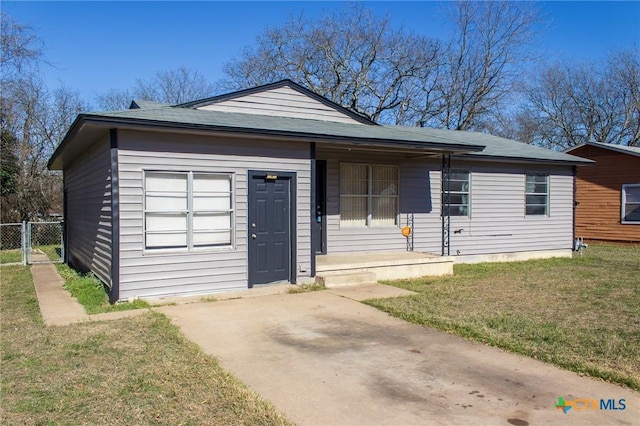 ranch-style home featuring covered porch and a front yard