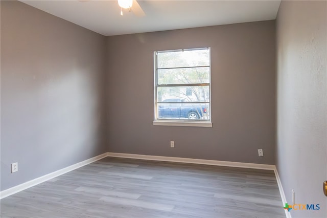 unfurnished room with ceiling fan and light hardwood / wood-style flooring