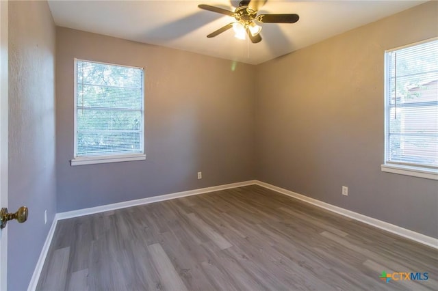 spare room with ceiling fan and hardwood / wood-style flooring