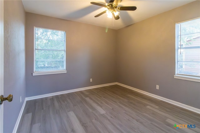 unfurnished room featuring ceiling fan, hardwood / wood-style floors, and plenty of natural light